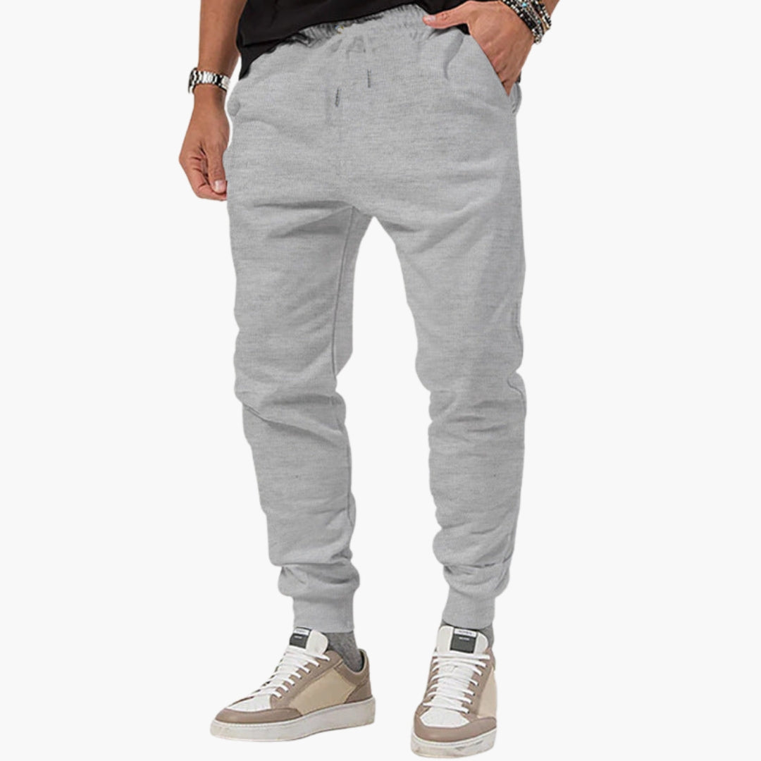 Men's tapered athletic joggers with elastic drawstring waist, side pockets, and pull-on cuffed design
