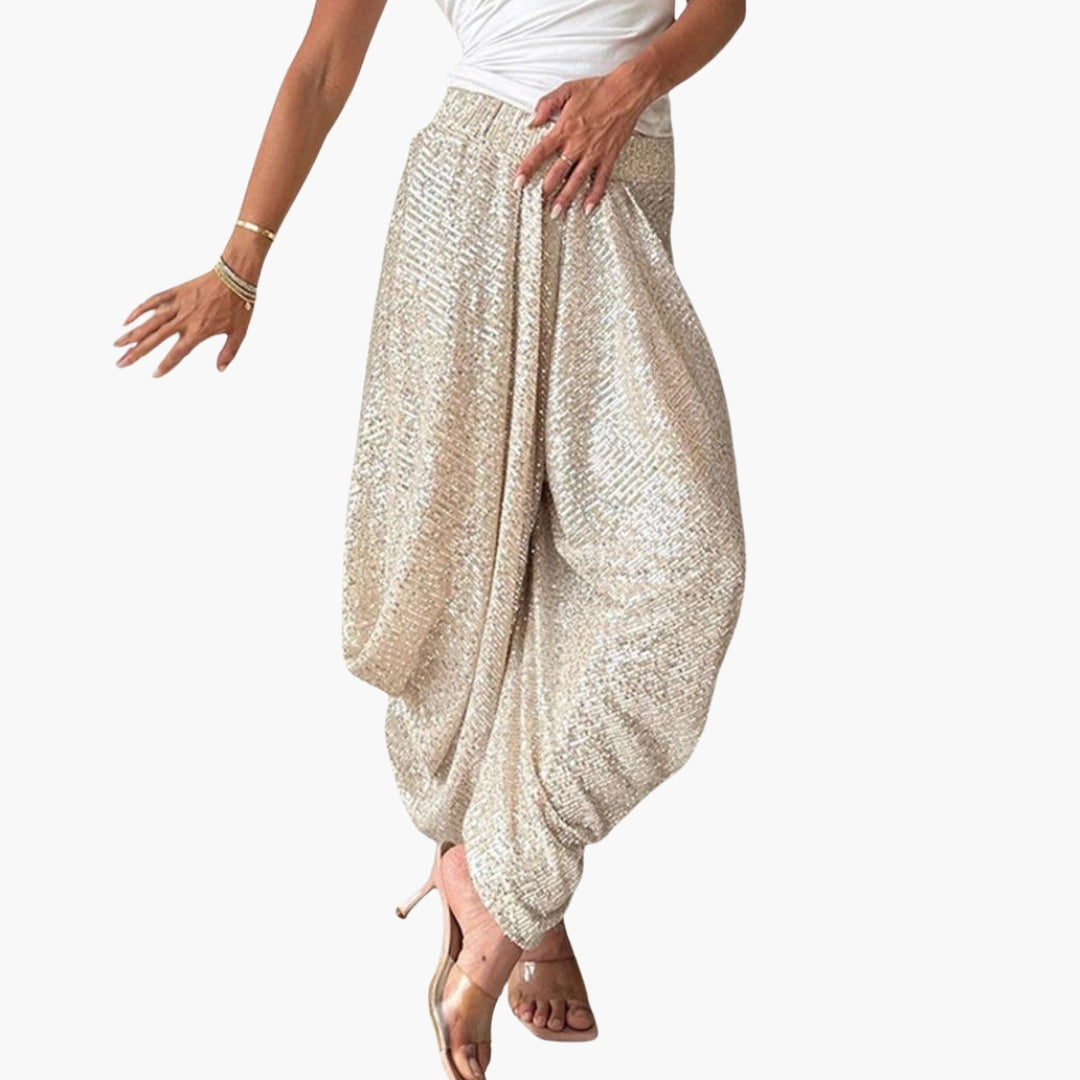 Women's glittered high-waisted wide-leg pants with draped ankles, bold glamorous evening silhouette