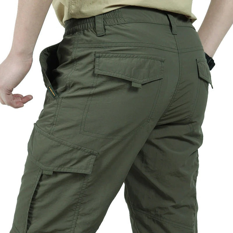Men's slim fit cargo pants in neutral tone with multiple utility pockets for everyday wear