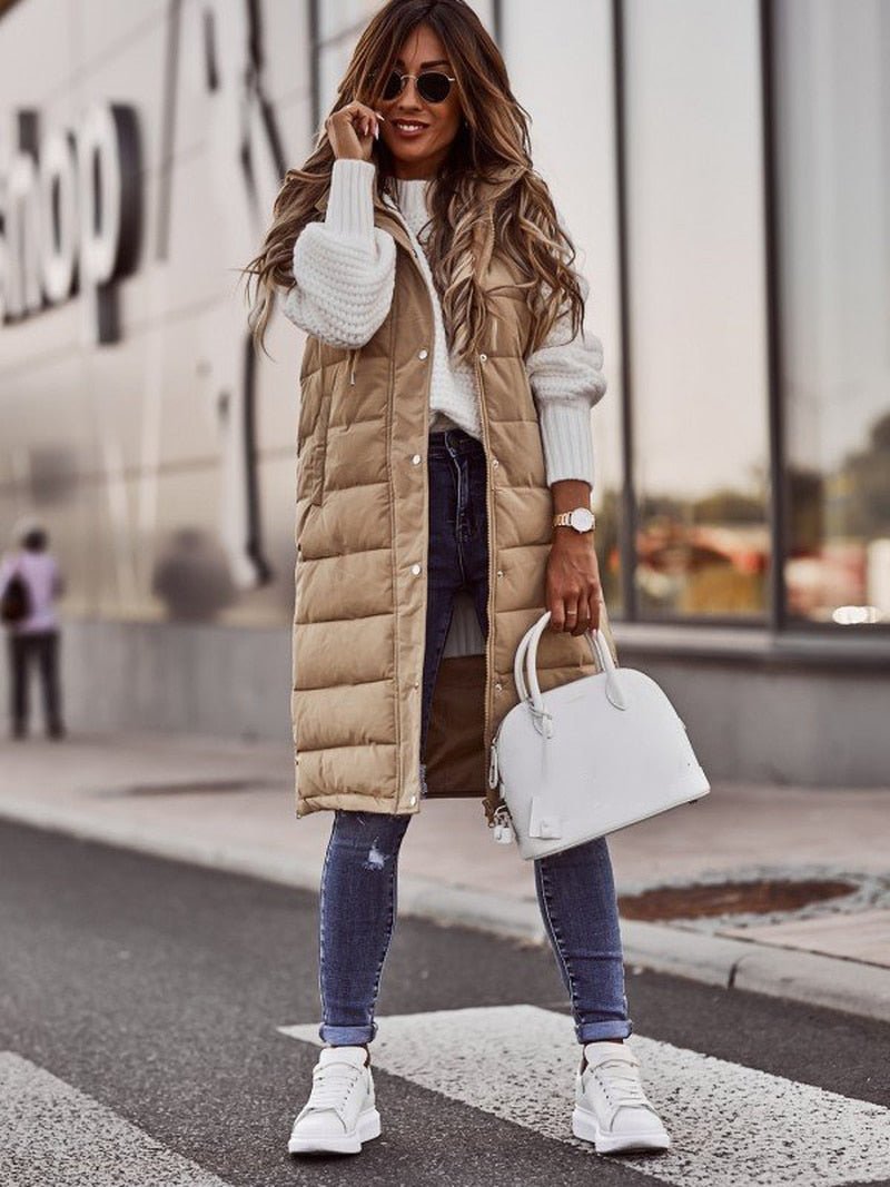 Women's quilted longline vest in neutral tones with stand collar and sleeveless chic silhouette