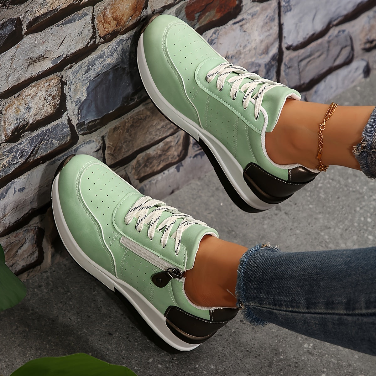 White women's low-top sneakers with breathable perforated design and cushioned lace-up sole