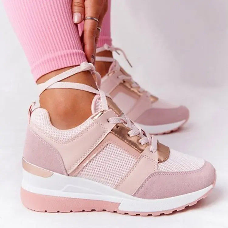 Women's white perforated wedge sneakers with hidden heel for all-day comfort and casual style
