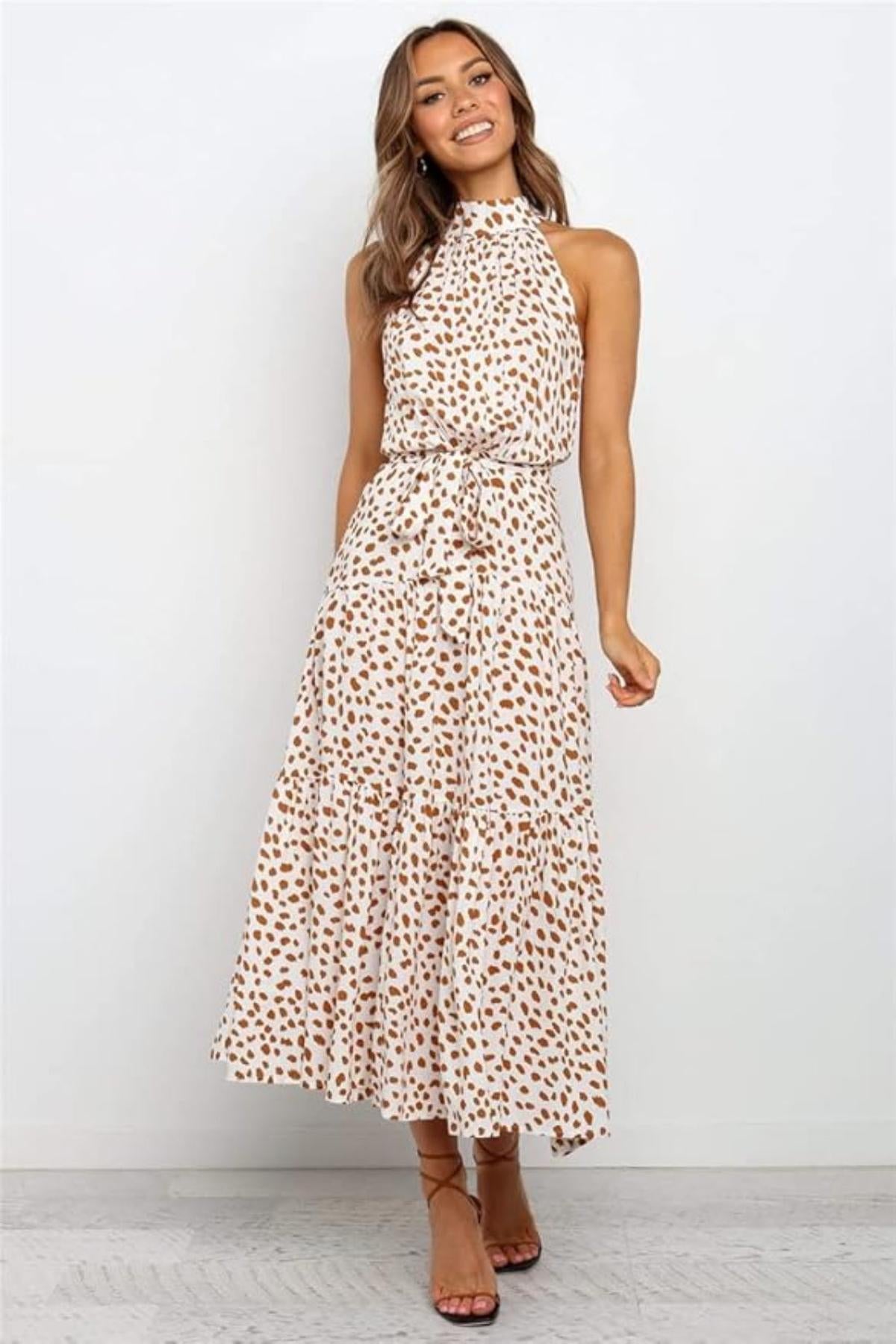 Black and white polka dot halter midi dress with adjustable waist tie, fit-and-flare silhouette