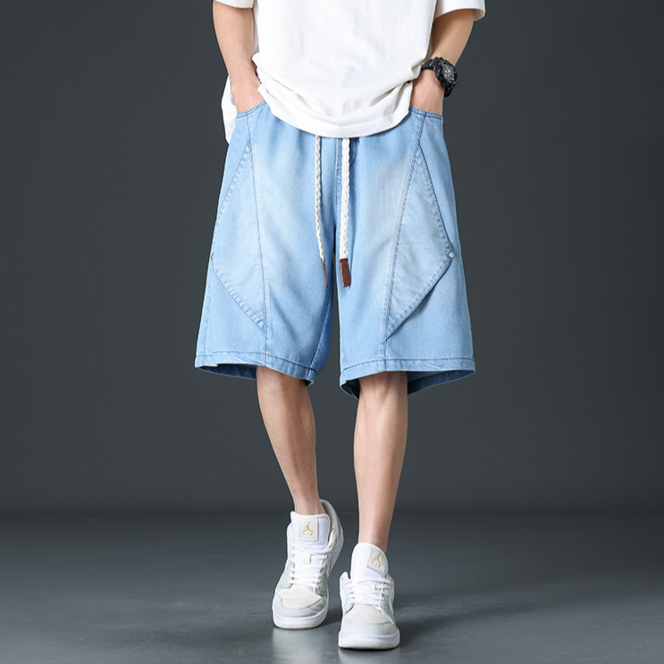 Washed black wide leg denim shorts with futuristic panel seams and adjustable rope tie waistband