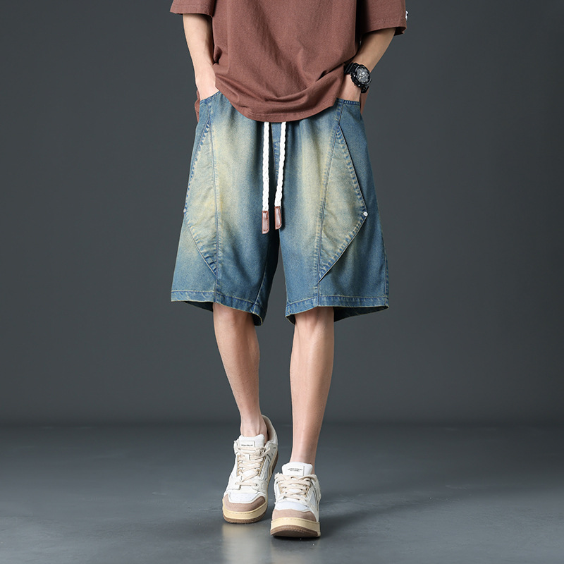 Washed black wide leg denim shorts with futuristic panel seams and adjustable rope tie waistband