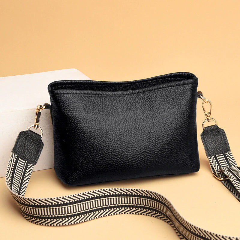 Black synthetic leather women's vintage sling bag with adjustable crossbody strap and spacious interior