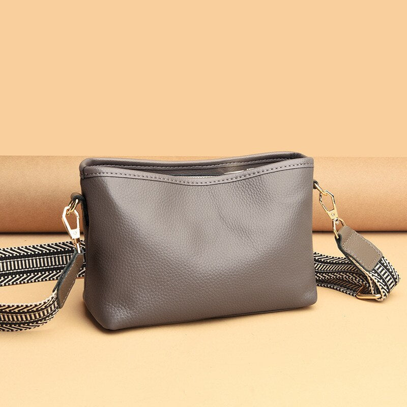 Black synthetic leather women's vintage sling bag with adjustable crossbody strap and spacious interior