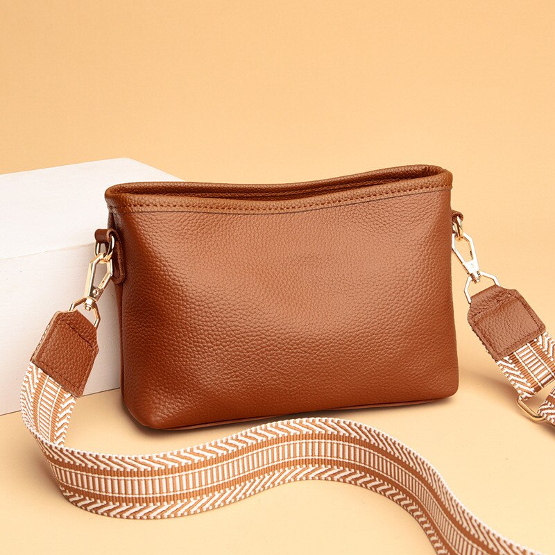 Black synthetic leather women's vintage sling bag with adjustable crossbody strap and spacious interior