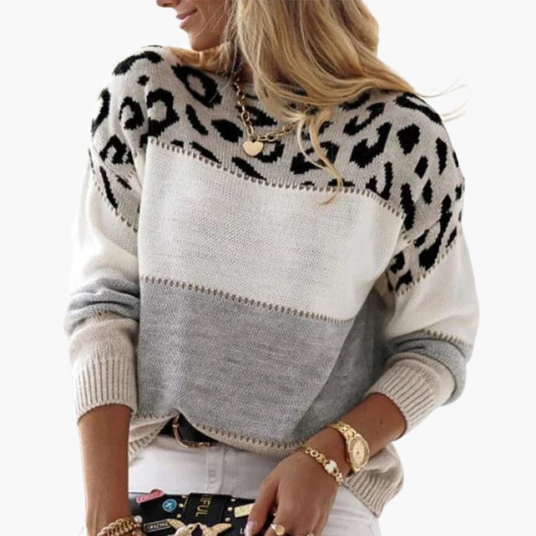 Women's round neck knit pullover with contrasting animal-inspired pattern and ribbed cuffs