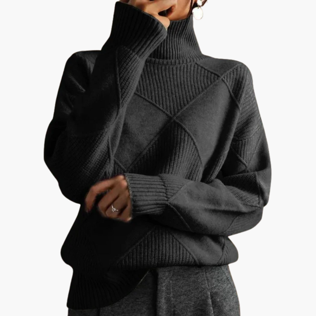 Women's loose-fit wool knit sweater in cozy neutral tones with ribbed mock neck and geometric texture