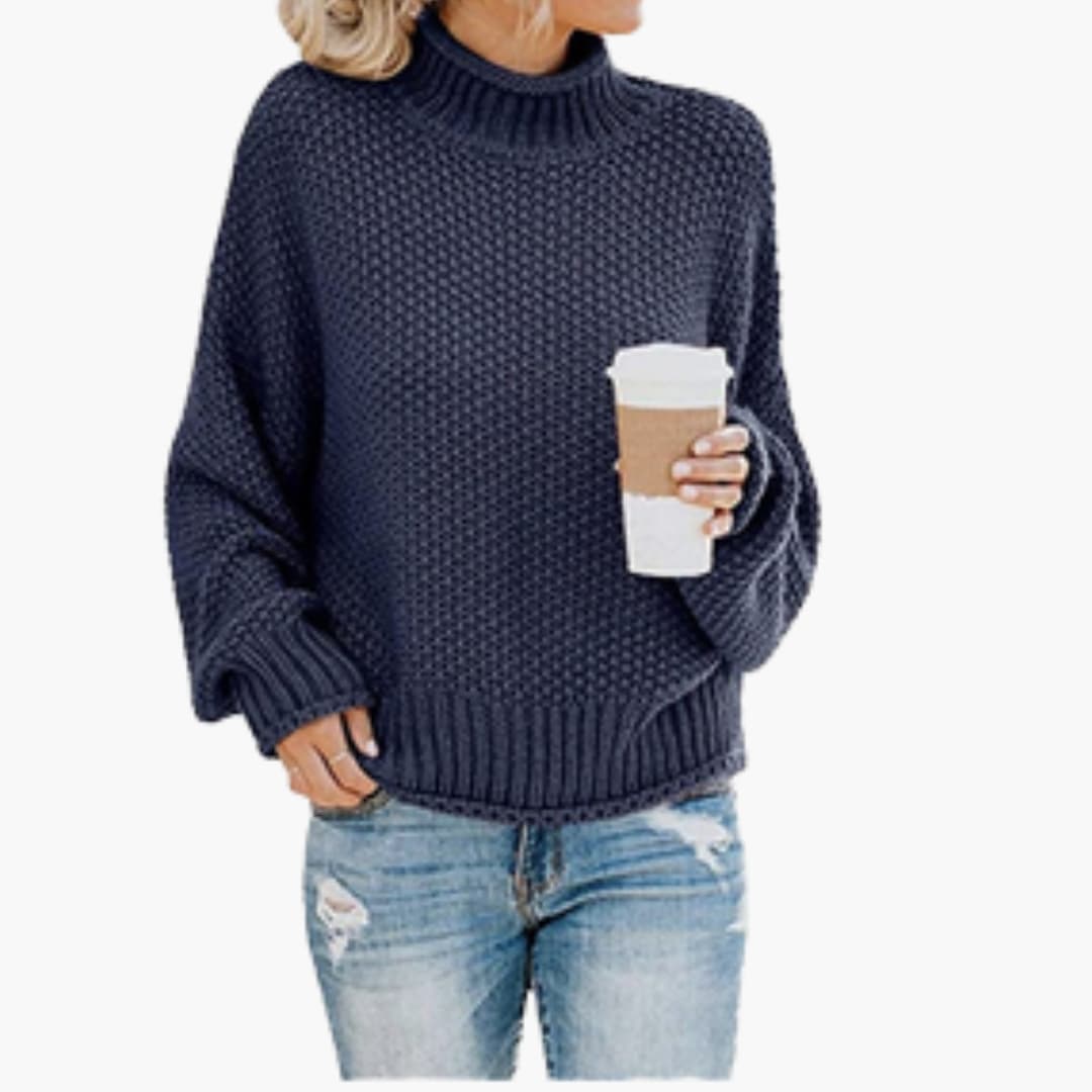 Women's cozy ivory turtleneck pullover with ribbed stand-up collar and textured knit surface