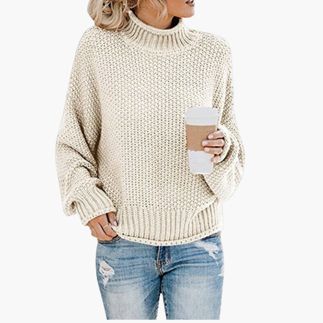 Women's cozy beige turtleneck pullover with ribbed stand-up collar and textured knit surface