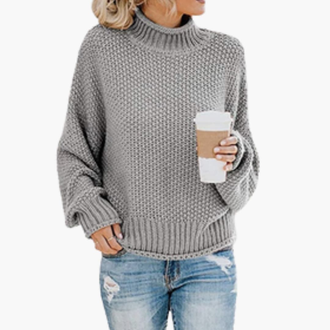 Women's cozy beige turtleneck pullover with ribbed stand-up collar and textured knit surface