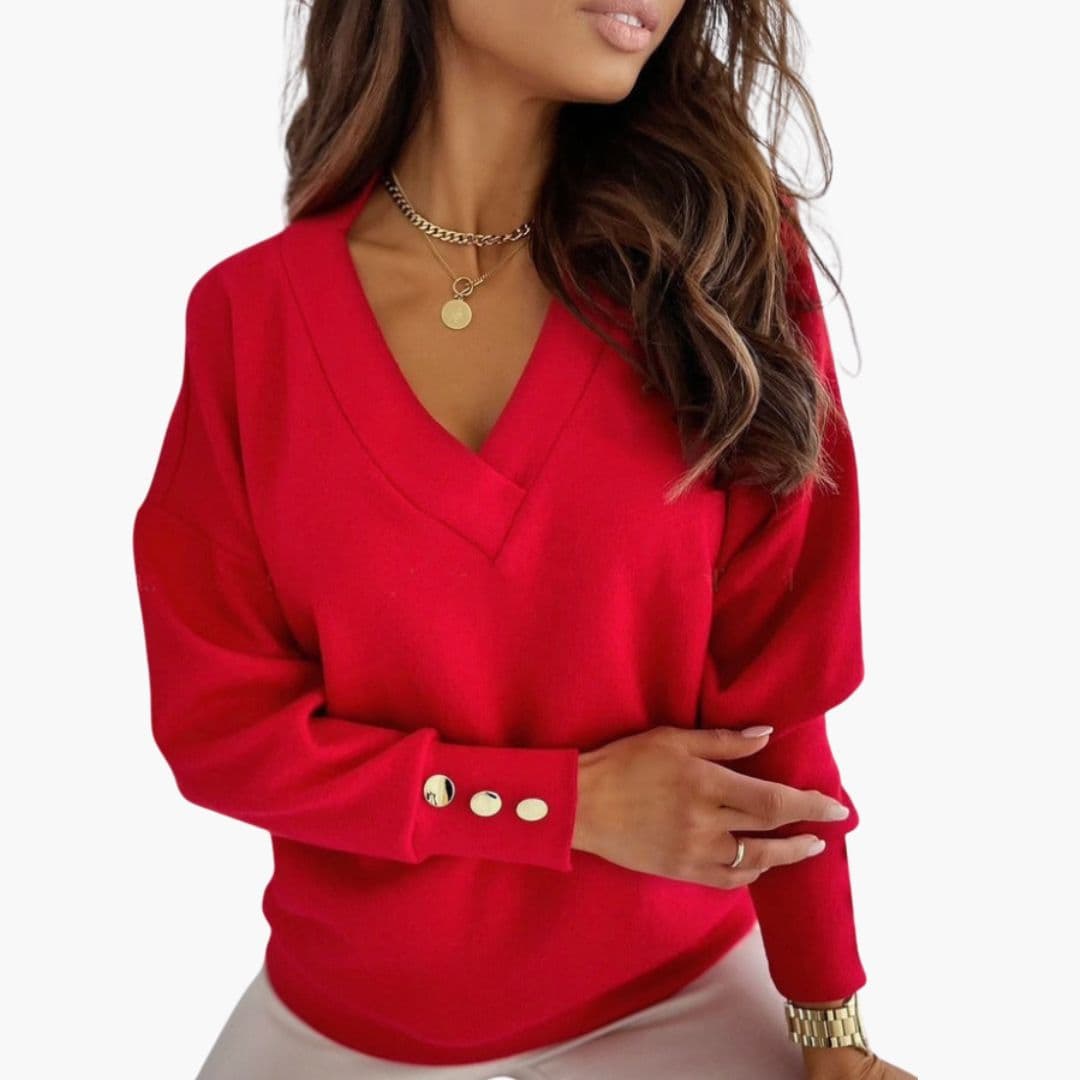Women's relaxed solid knit V-neck sweater with dropped shoulders and decorative button cuffs