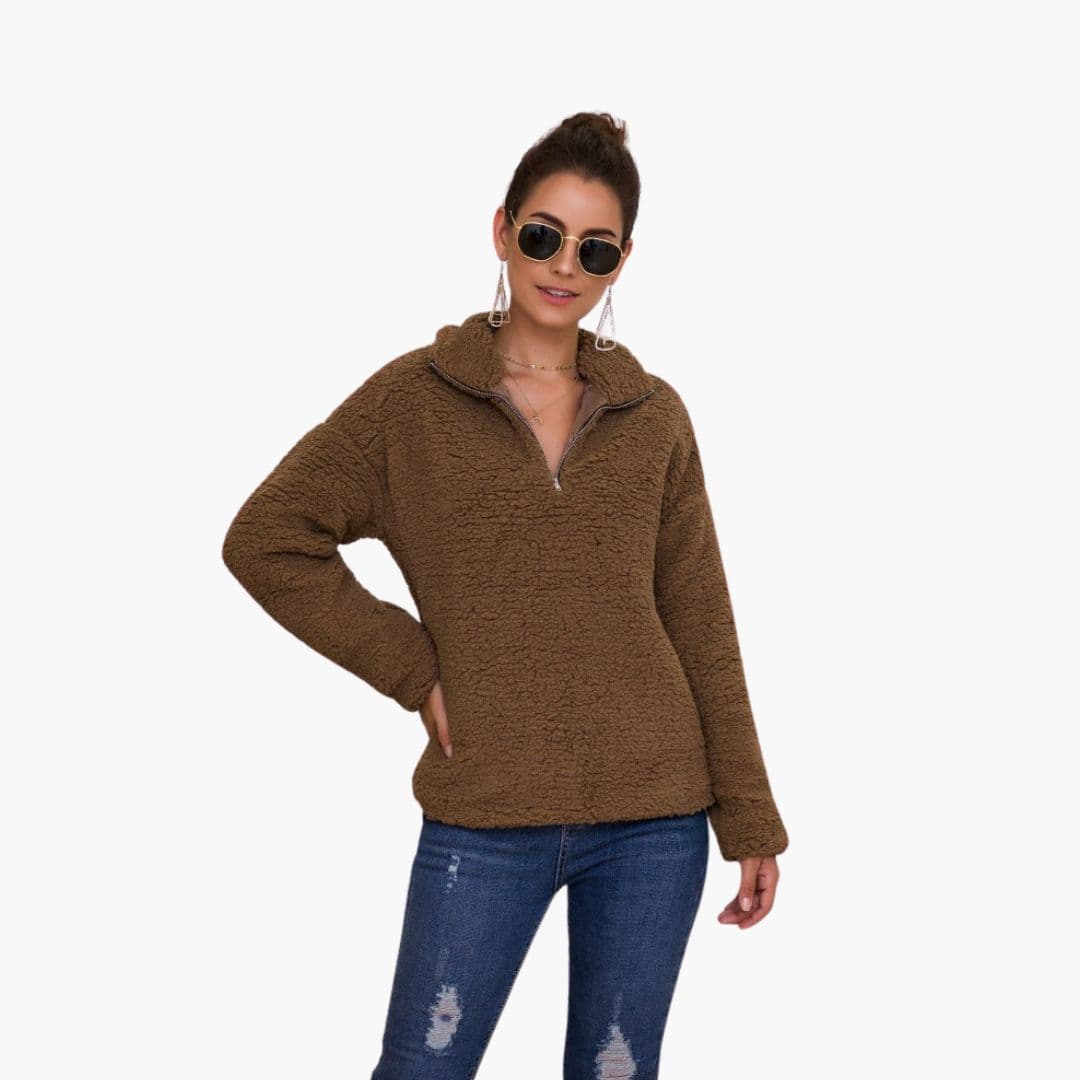 Women's cozy loose fit fleece pullover with textured surface, stand-up collar, and half-zip closure