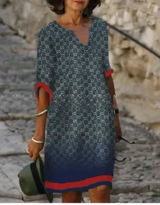 Women's floral midi dress with V-neck, artistic face print, floral accents, sophisticated everyday style
