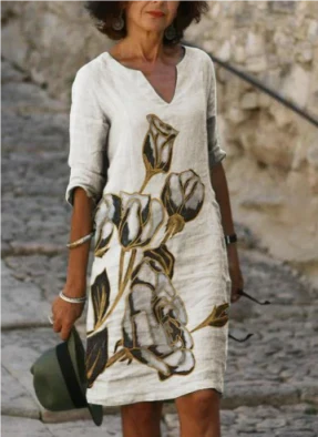 Women's floral midi dress with V-neck, artistic face print, and delicate floral accents for everyday chic