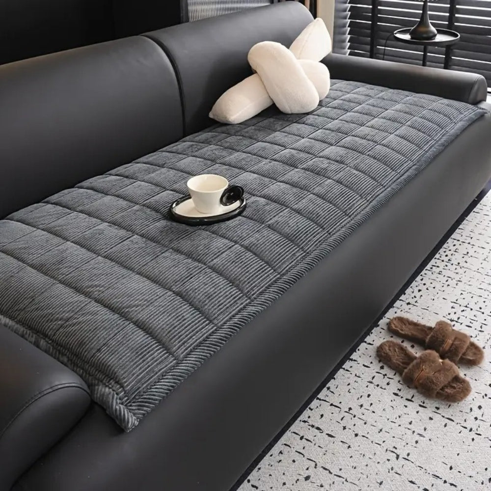 Quilted sofa cover with non-slip backing, pet-friendly couch protector in neutral tones