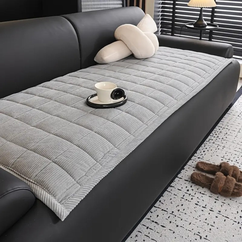 Quilted sofa cover with non-slip backing, pet-friendly protective throw in neutral tones