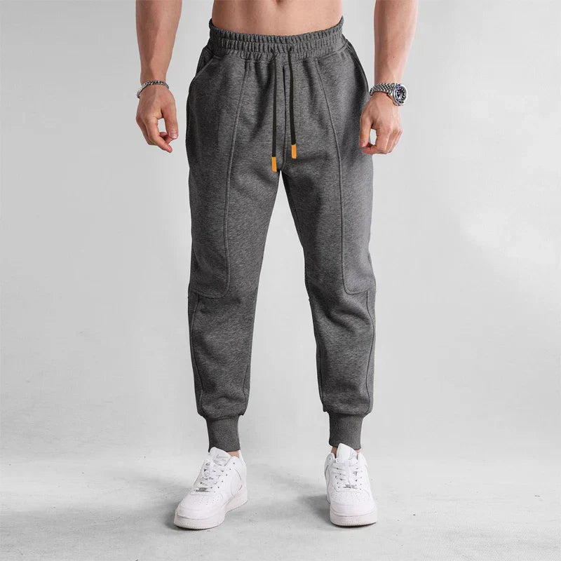 Men's gray cotton joggers with elastic drawstring waist, slim athletic cut for training and everyday wear