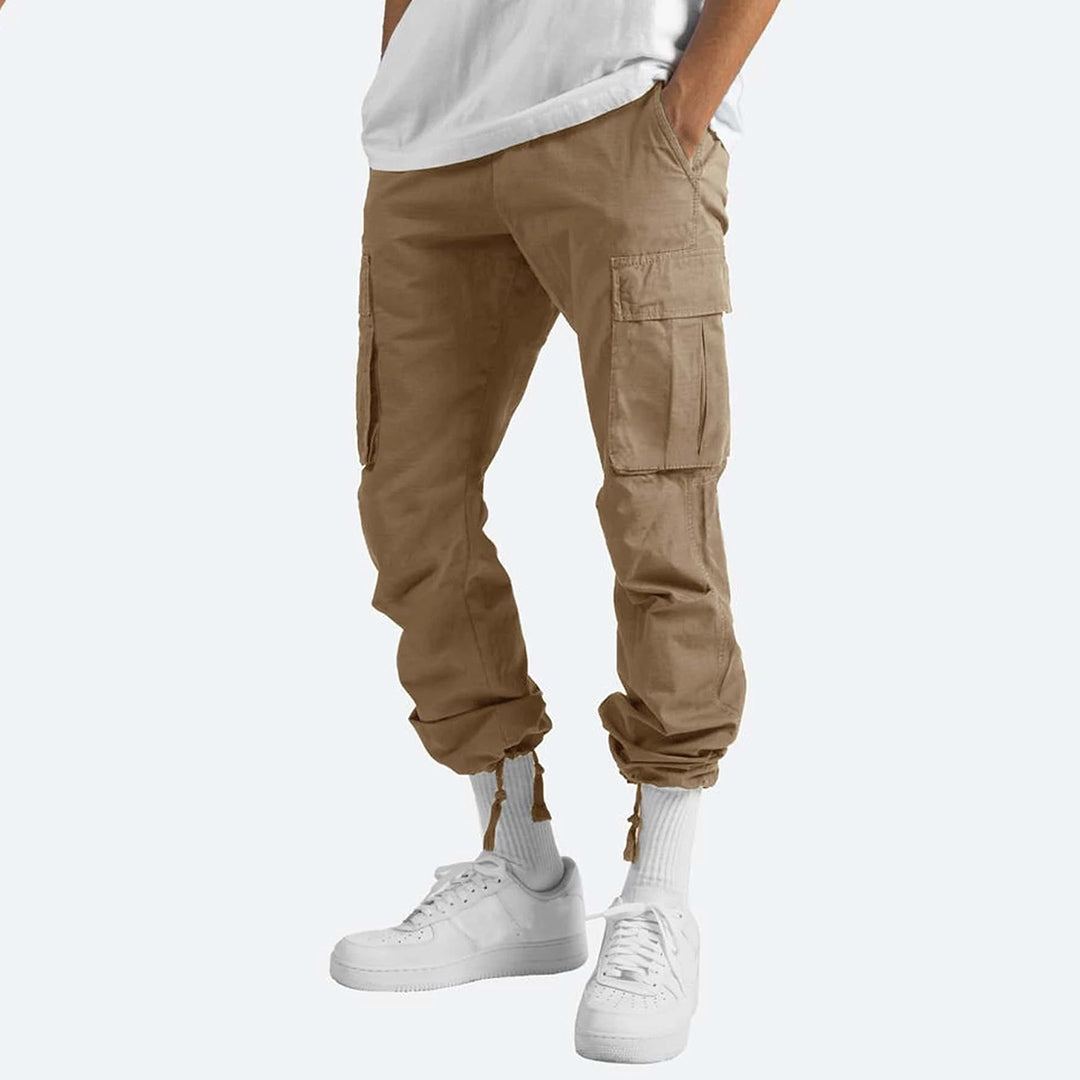 Men's relaxed fit cargo pants in neutral tone, multiple utility pockets, durable cotton blend streetwear style