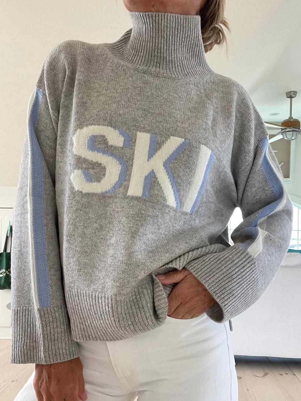 Cream oversized turtleneck ski jumper with bold intarsia stripes and retro vintage knit design