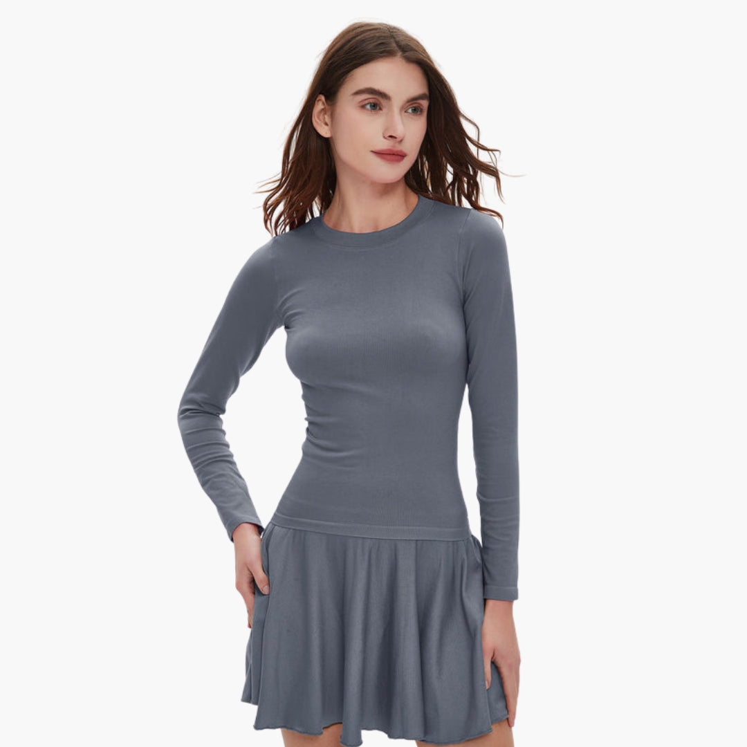 Women's long sleeve round neck dress with fitted waist, fluid draped skirt, and side pockets