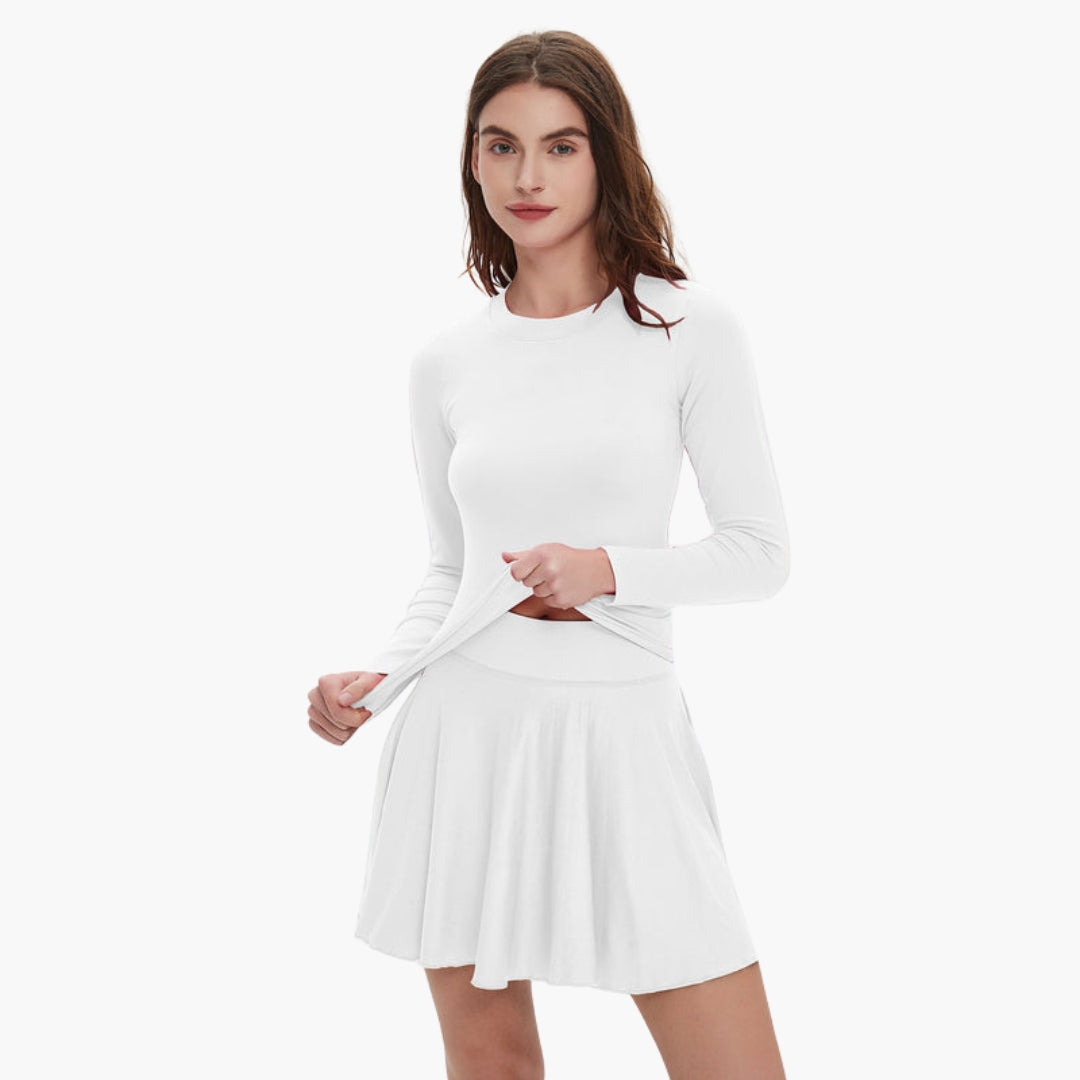 Women's long sleeve round neck dress with fitted waist, fluid draped skirt, and side pockets