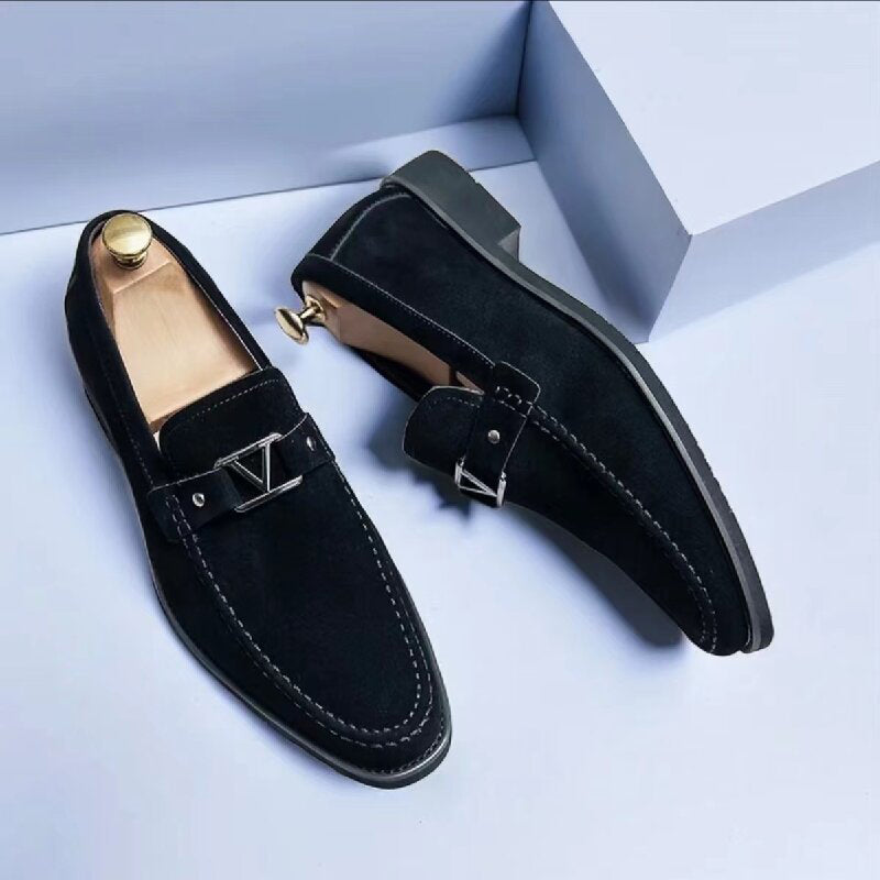 Men's brown suede slip-on loafers with sleek low-profile silhouette and polished metal detail