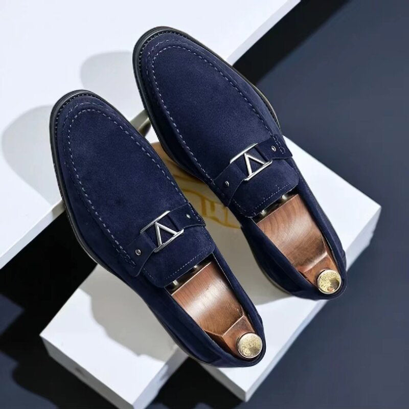 Men's brown suede slip-on loafers with sleek low-profile silhouette and polished metal detail