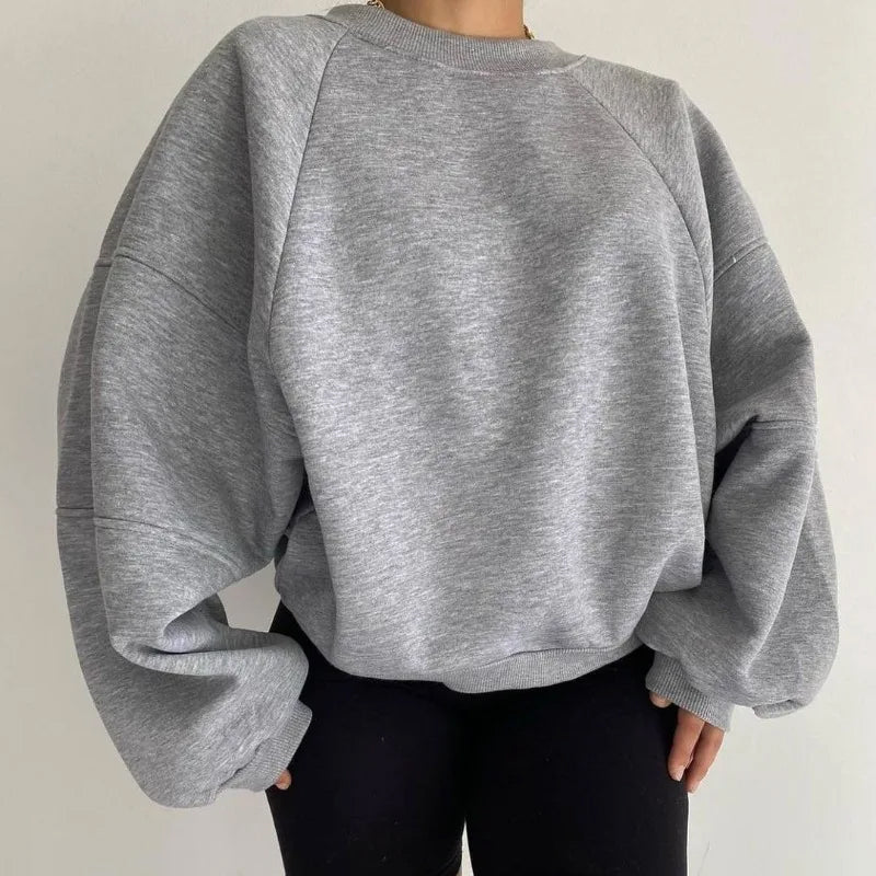 Women's oversized winter pullover sweatshirt in cozy plush fabric with relaxed drop-shoulder fit