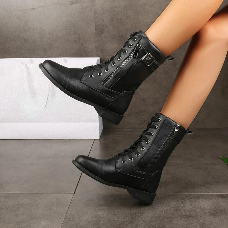 Women's black mid-calf combat boots with lace-up front, rugged buckle detail, and side zip closure