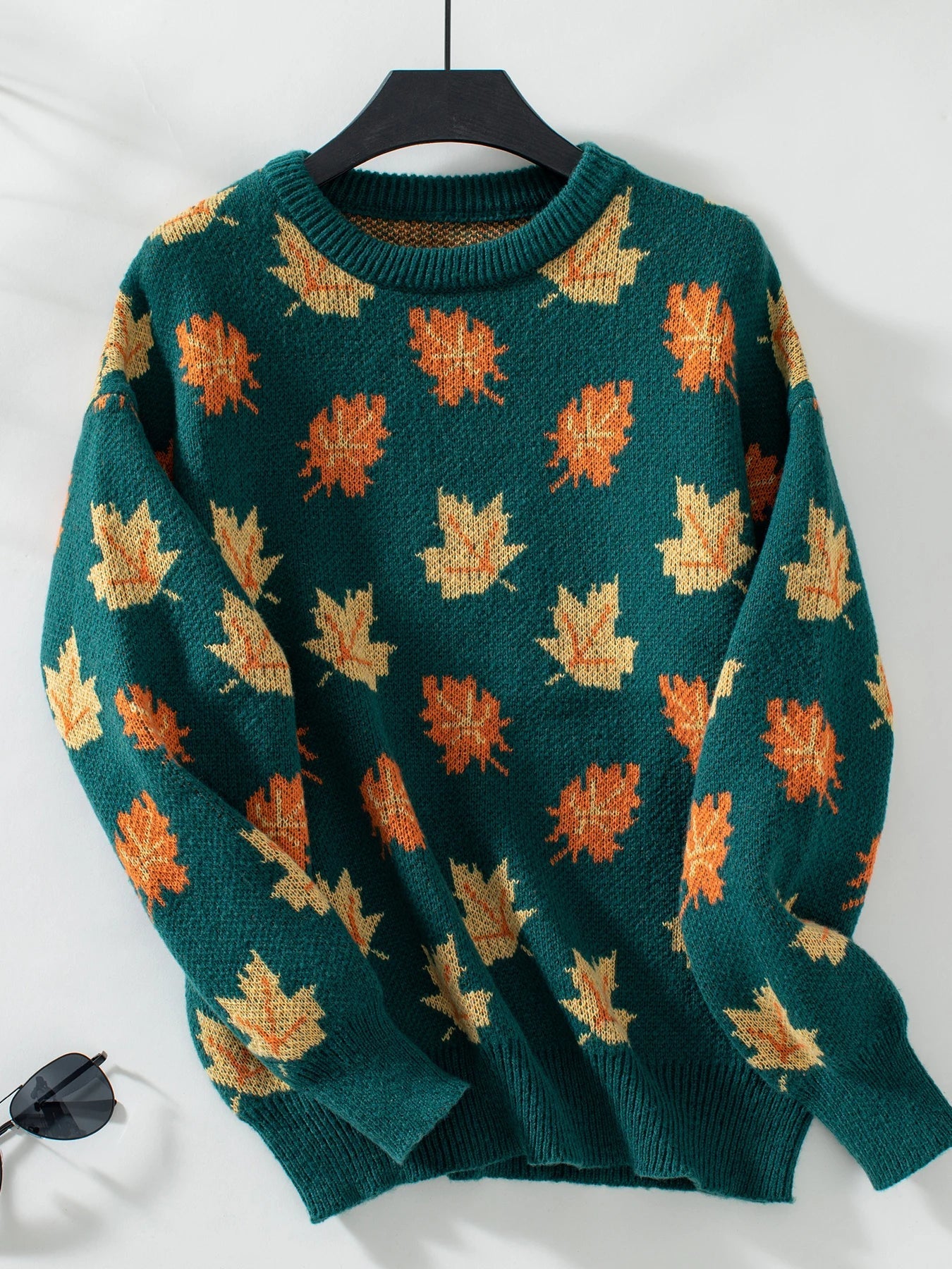 Women's cozy knitted pullover sweater with vibrant autumn leaf motif, warm transitional fall style