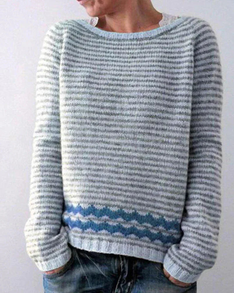 Women's winter knit sweater with bold color transitions and cozy patterned upper motif