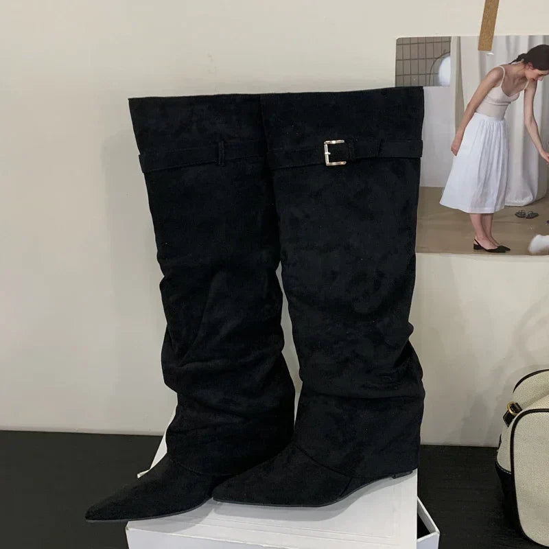 Women's black leather thigh-high boots with silver buckle accent, flattering silhouette