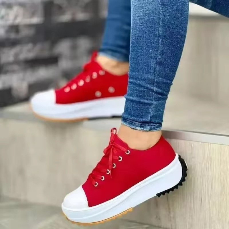 Women's white canvas platform sneakers with breathable upper, lightweight sole, and subtle height boost