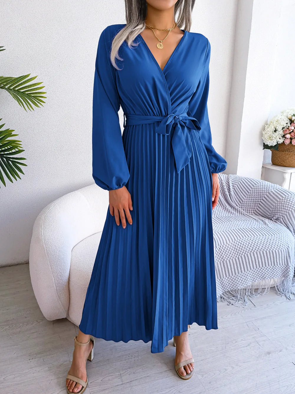 Women's maxi dress flowing silhouette deep V-neck long sleeves soft pleats floor-length elegant style