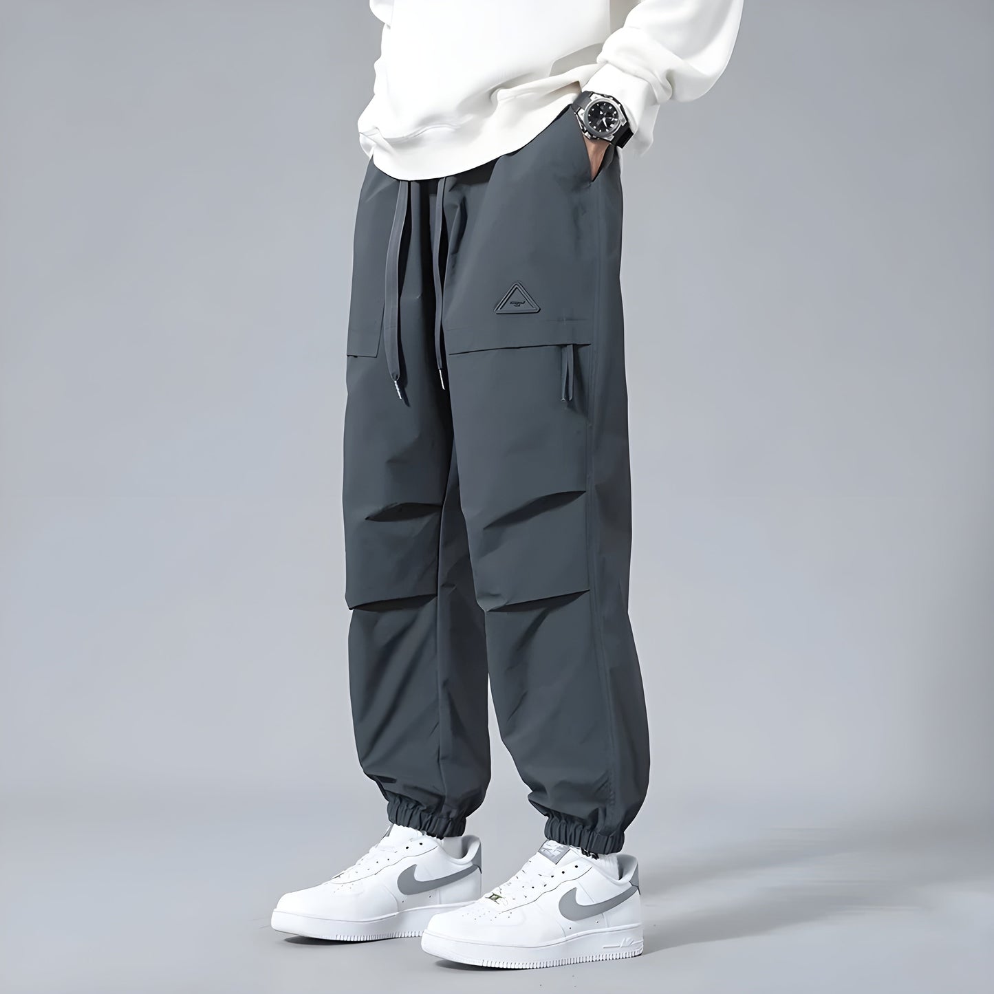 Men's relaxed fit cargo pants with elastic drawstring waist, multiple cargo pockets, utility style