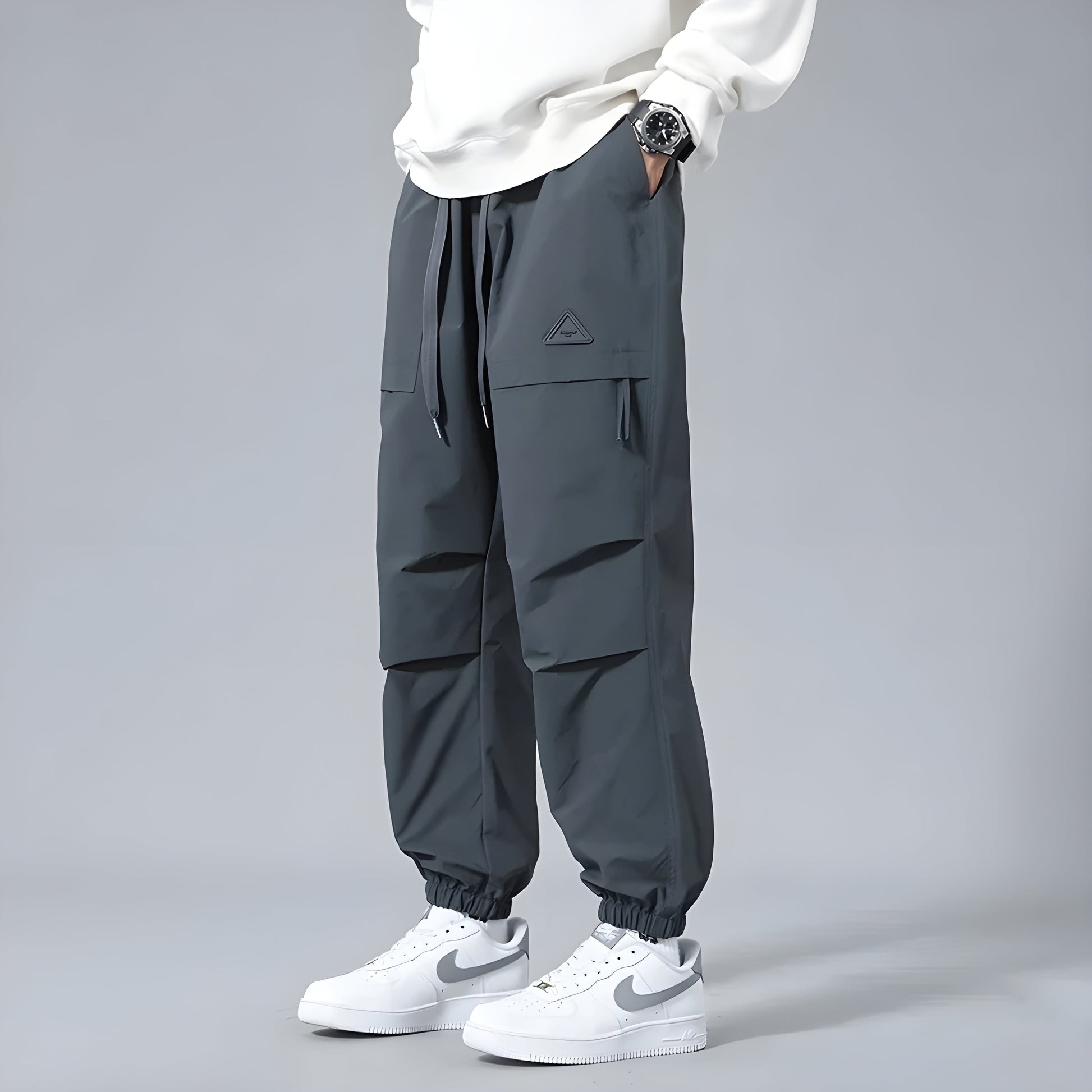Men's relaxed fit cargo pants with elastic drawstring waist, multiple cargo pockets, utility style