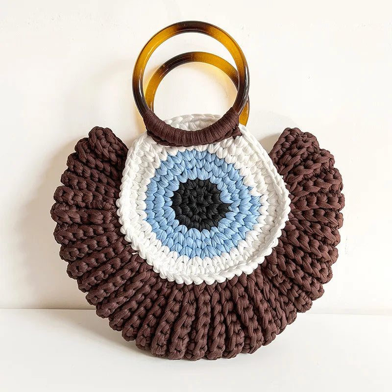 Handwoven evil eye mini clutch bag in blue talisman motif, compact boho-chic everyday accessory