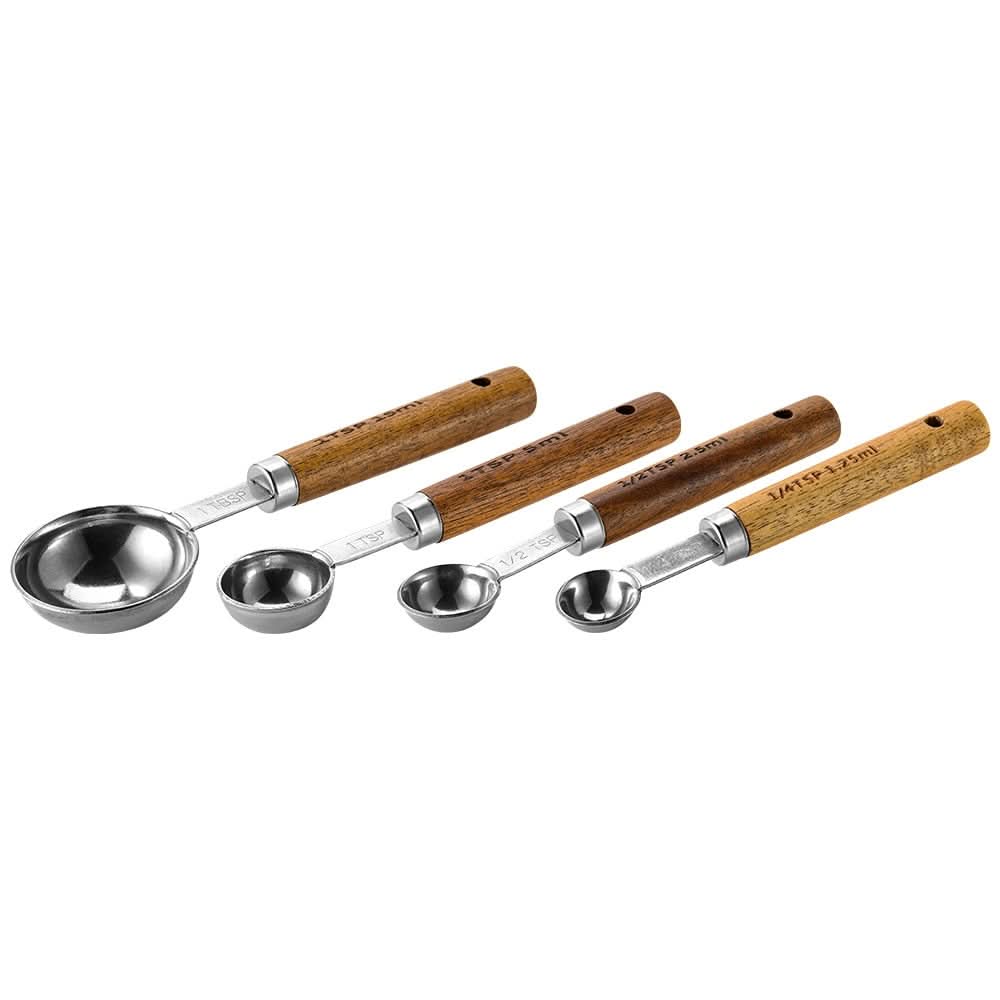Gold-toned metal measuring cup set with wood handles, engraved markings, elegant kitchen tool