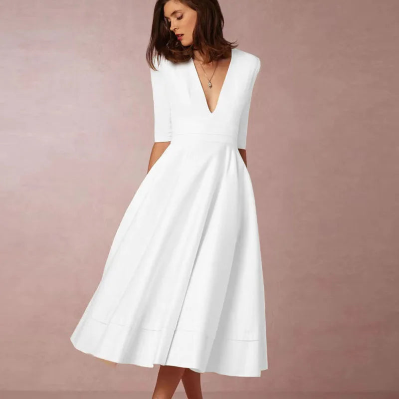Elegant black A-line midi dress with deep V-neck, textured luxurious fabric, and three-quarter sleeves
