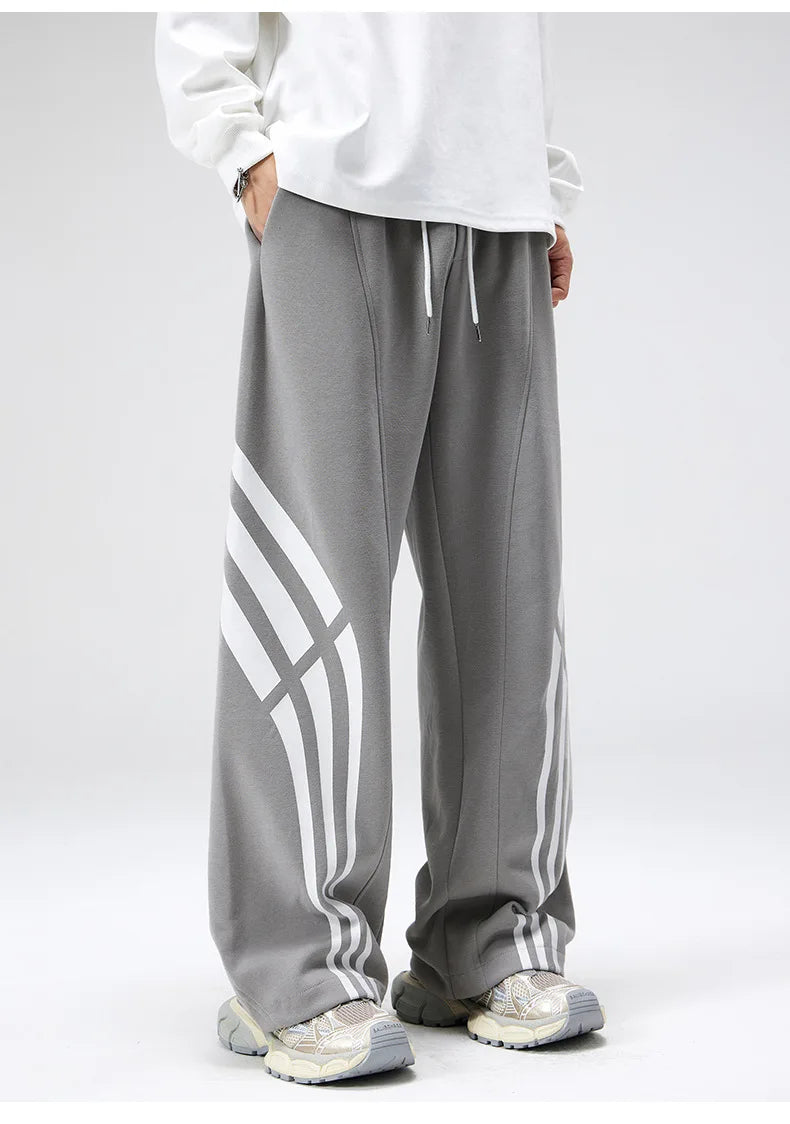 Black straight fit sweatpants with vintage wraparound stripe, wide leg silhouette for streetwear