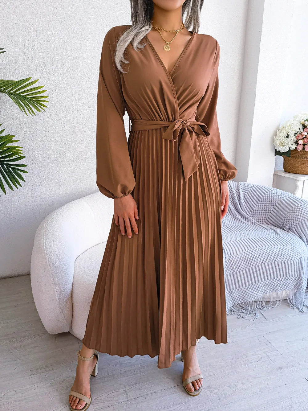 Women's flowing maxi dress with deep V-neck, soft pleats, long sleeves, relaxed silhouette