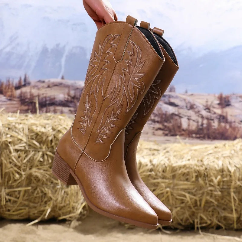 Women's brown mid-calf western boots with pointed toe, block heel, and classic cowboy stitching