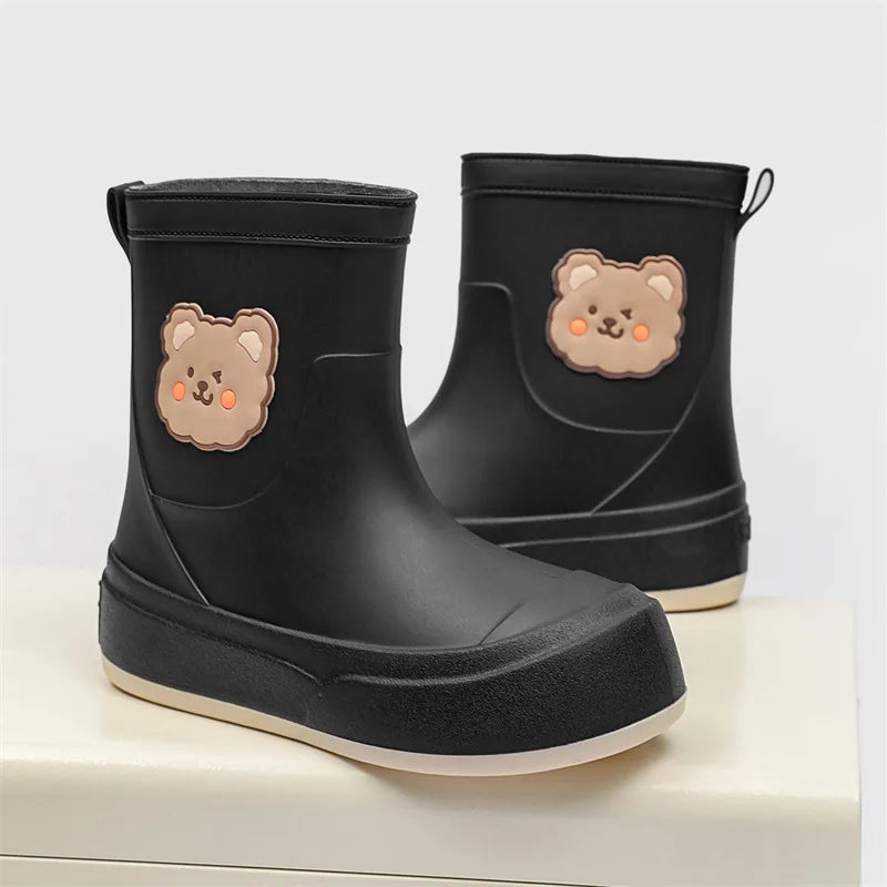 Women black ankle-height rubber rain boots pull-on style with whimsical bear motif waterproof design