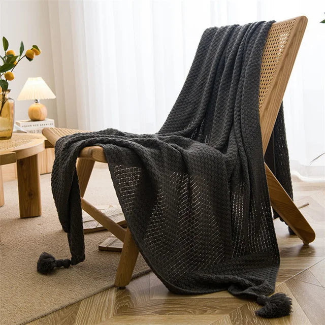 Cream handknit Nordic throw blanket with tassel fringe, ultra-soft cozy style for beds and couches