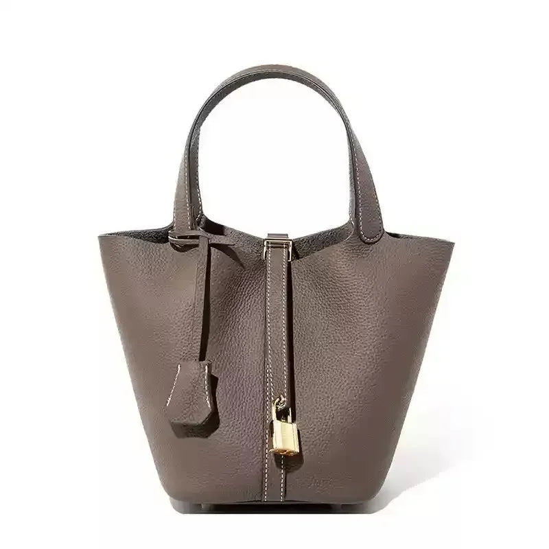 Structured grain leather tote bag for women, elegant everyday carry with secure strap closure