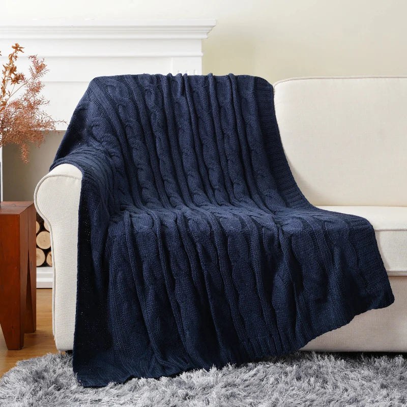 Ultra-soft cable knit throw blanket in neutral tones with rich textured stitching for bed and sofa decor