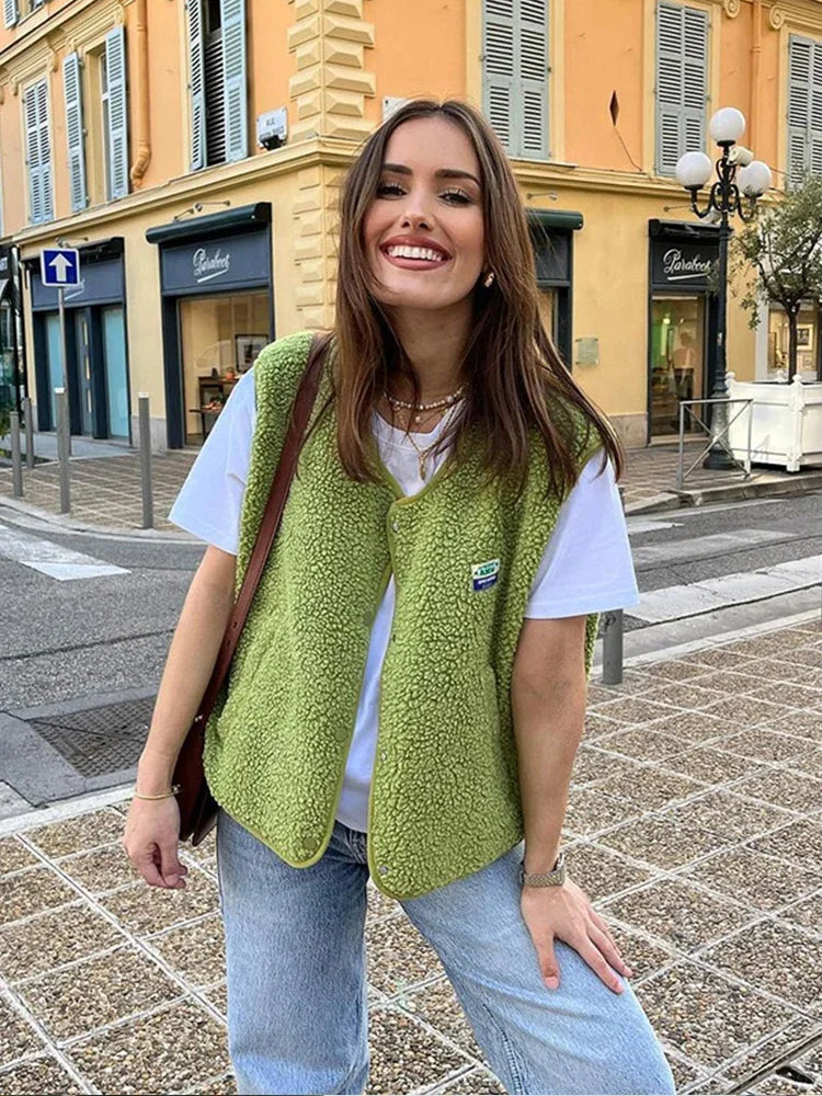 Women's oversized open-front sherpa fleece vest in casual layering style with high-pile texture